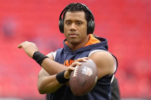 Denver Broncos quarterback Russell Wilson (3) warms up before the NFL football game between Denver Broncos and Jacksonville Jaguars at Wembley Stadium London, Sunday, Oct. 30, 2022. (AP Photo/Kirsty W ...