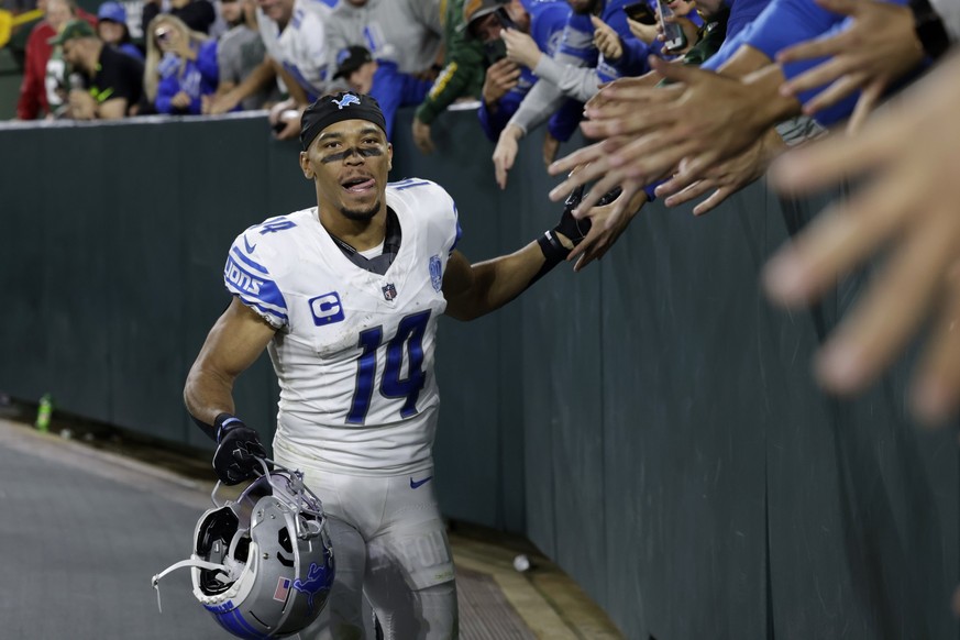 Detroit Lions wide receiver Amon-Ra St. Brown (14) celebrates with fans after an NFL football game against the Green Bay Packers, Thursday, Sept. 28, 2023, in Green Bay, Wis. The Lions won 34-20. (AP  ...