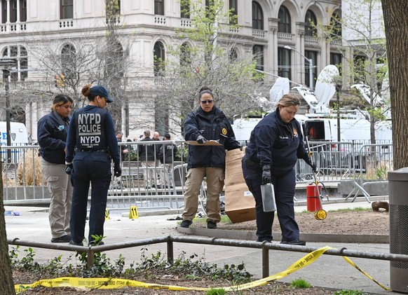 April 19, 2024, New York, New York, USA: In the aftermath of Max Azzarello, who self-immolated, the NYPD crime scene unit inspects the area where this took place in the park across from the NYS Crimin ...