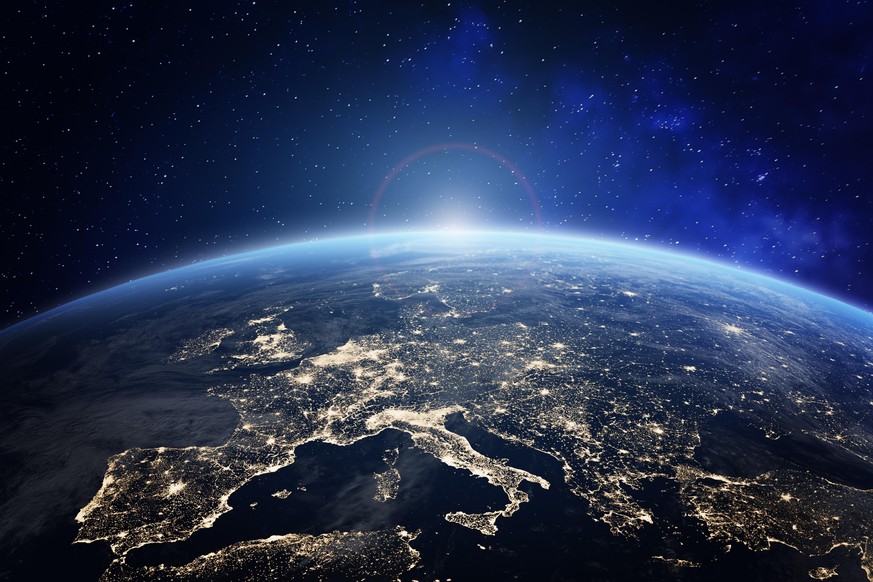 Planet Earth viewed from space with city lights in Europe. World with sunrise. Conceptual image for global business or European communication technology, elements from NASA