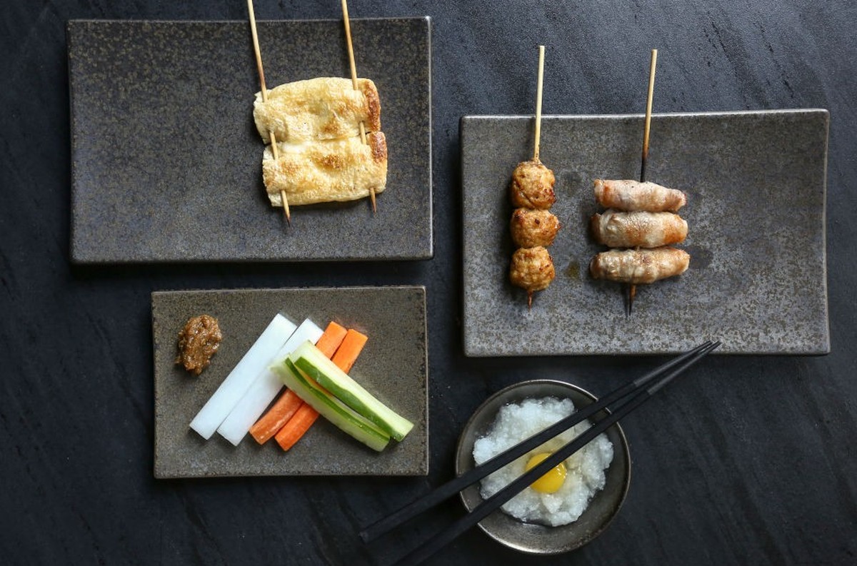 Fried tofu stuffed with raclette cheese, meatball, and ginger wrapped with pork belly skewer&#039;s from Toritama in Central. 17OCT14. [23OCT14 48Hrs FIRST SERVED] (Photo by JONATHAN WONG/South China  ...