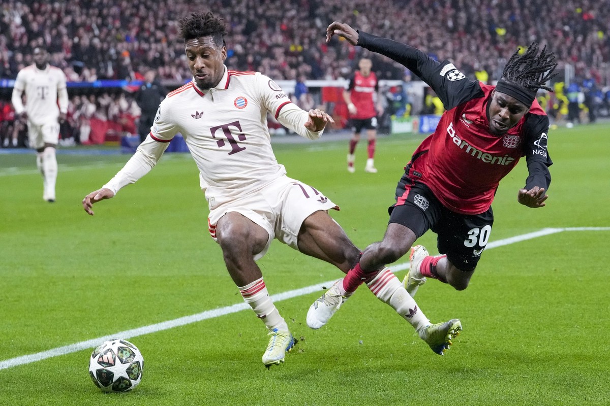 Bayern&#039;s Kingsley Coman, left, duels for the ball with Leverkusen&#039;s Jeremie Frimpong during the Champions League round of 16 second leg soccer match between Bayer Leverkusen and Bayern Munic ...