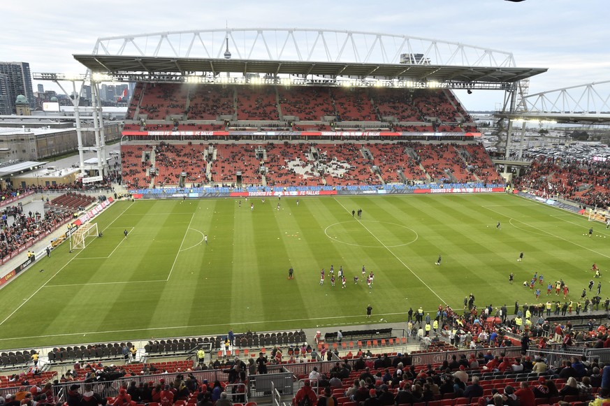 FILE - FC Dallas and Toronto FC players take pitch at the newly renovated BMO Field before the start of an MLS soccer match in Toronto on Saturday, May 7, 2016. There are 23 venues bidding to host soc ...
