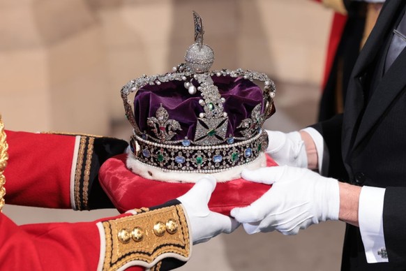 LONDON, ENGLAND - MAY 10: The Imperial State Crown arrives through the Sovereign's Entrance ahead of the State Opening of Parliament at Houses of Parliament on May 10, 2022 in London, England. The Sta ...