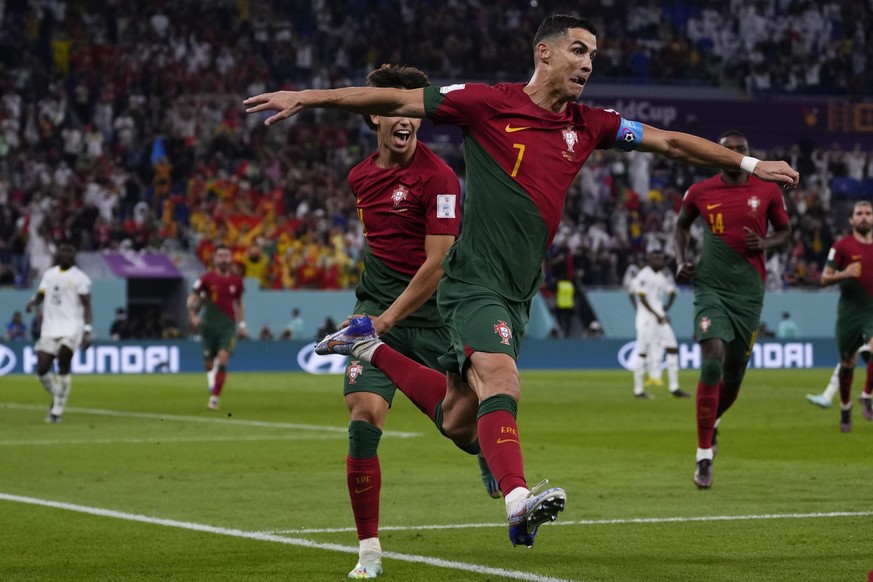 Portugal's Cristiano Ronaldo celebrates after scoring from the penalty spot his side's opening goal against Ghana during a World Cup group H soccer match at the Stadium 974 in Doha, Qatar, Thursday, N ...