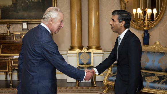 King Charles III welcomes Rishi Sunak during an audience at Buckingham Palace, London, where he invited the newly elected leader of the Conservative Party to become Prime Minister and form a new gover ...