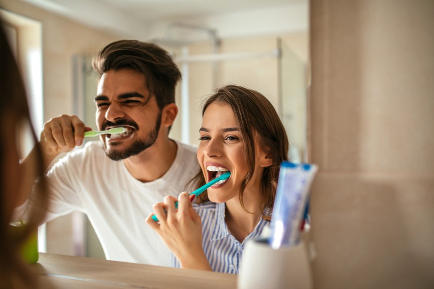 Couple doing a morning hyginene together.