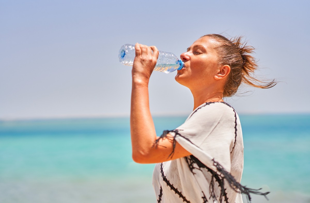 Picture of woman drinking water in warm day in Egypt. High quality photo
