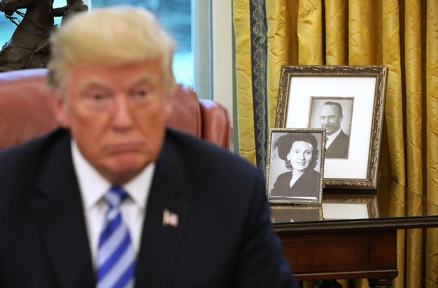 WASHINGTON, DC - AUGUST 28: Framed photographs of U.S. President Donald Trump&#039;s parents, Fred and Mary Trump, sit on a table in the Oval Office while the president meets with FIFA President Giann ...