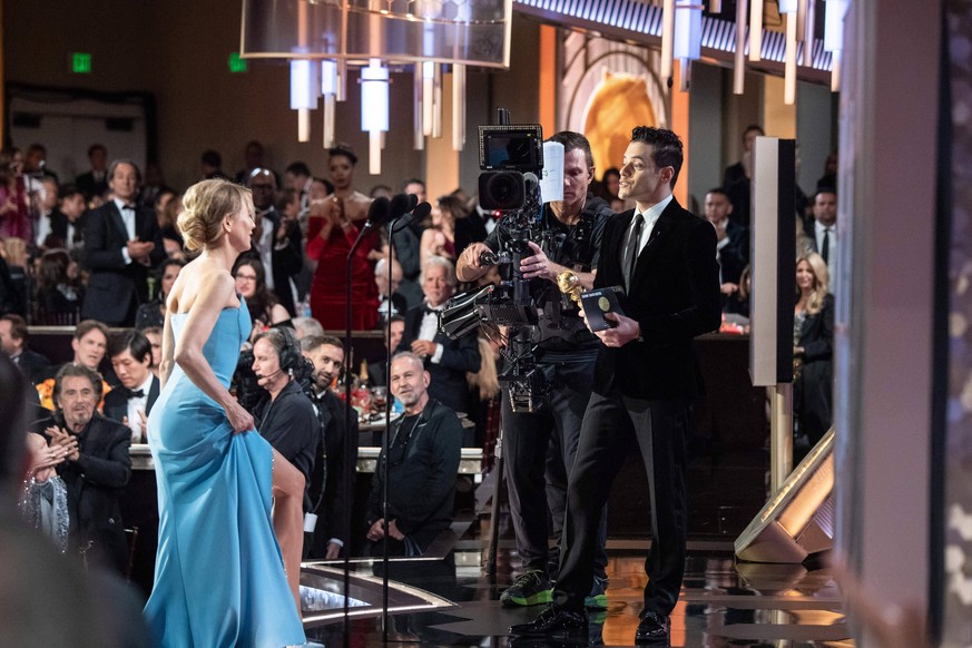 Renee Zellweger accepts the Golden Globe Award for Best Performance by an Actress in a Motion Picture - Drama for her role in Judy from presenter, Rami Malek, at the 77th Annual Golden Globe Awards at ...