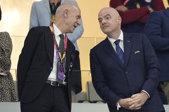 German Football Association President Bernd Neuendorf, left, speaks to FIFA President Gianni Infantino during the World Cup group E soccer match between Costa Rica and Germany at the Al Bayt Stadium i ...