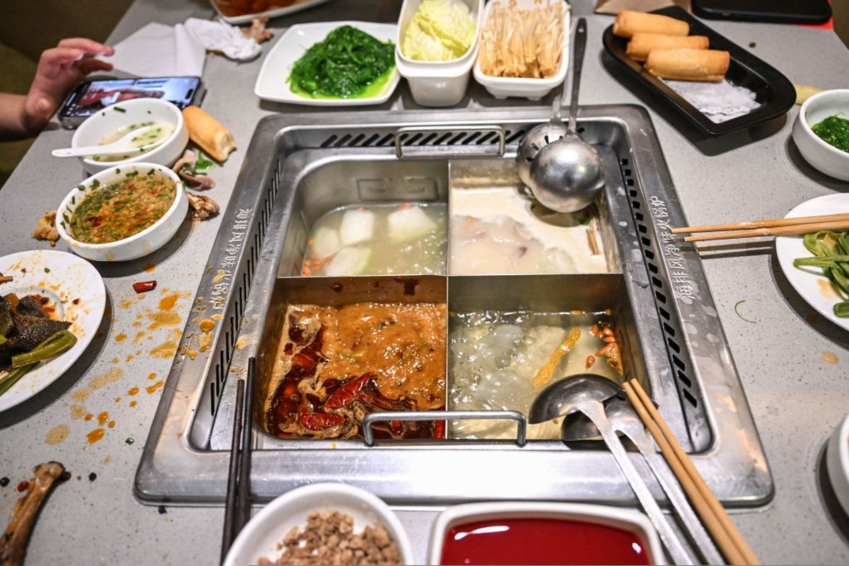 People dine in a Haidilao hot pot restaurant in a shopping mall complex in Beijing on March 13, 2025. One of China&#039;s biggest restaurant chains has promised to refund thousands of customers after  ...