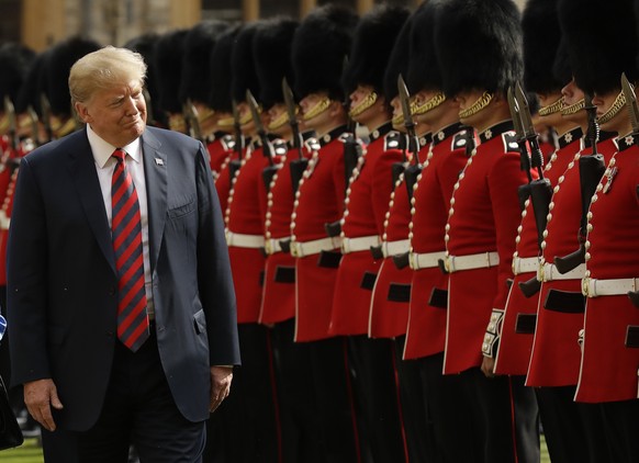 U.S. President Donald Trump inspects a Guard of Honour, formed of the Coldstream Guards at Windsor Castle in Windsor, England, Friday, July 13, 2018.(AP Photo/Matt Dunham, Pool)