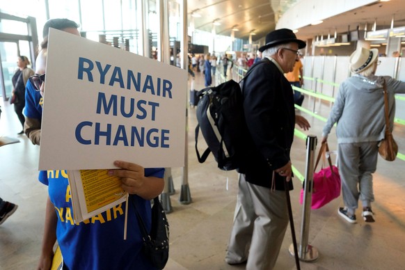 A Ryanair worker takes part in a protest inside the departure hall during a strike by Ryanair workers of several European countries, at the airport in Valencia, Spain, September 28, 2018. REUTERS/Hein ...