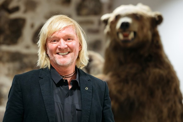 ARCHIV - 07.01.2020, Thüringen, Gotha: Andreas Kieling, Naturfotograf und Tierfilmer, steht im KunstForum Gotha bei der Vernissage zu seiner Ausstellung «Mit den Grizzlys durch Alaska» neben einem Prä ...