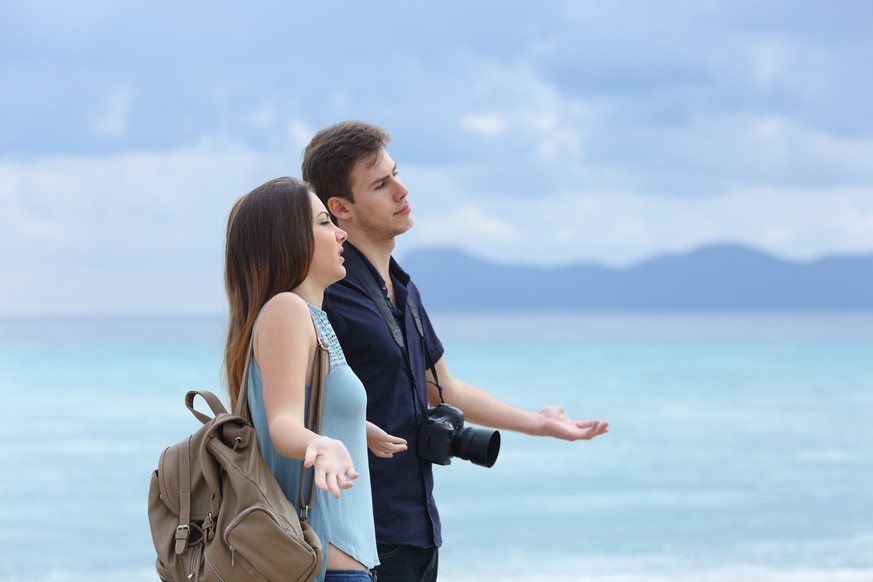 Angry couple of tourists complaining about bad weather