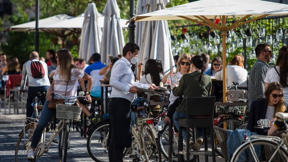 May 4, 2020, Ljubljana, Slovenia: People relax on the outdoor terrace cafe shop at the city center as Slovenia eases its lockdown..Outdoor terrace bars, restaurants along with beauty and hair salons,  ...