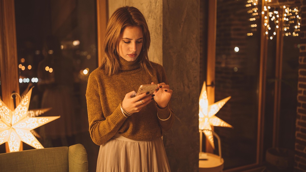 People feel alone on new year party, they standing out from the crowd and using mobile phone