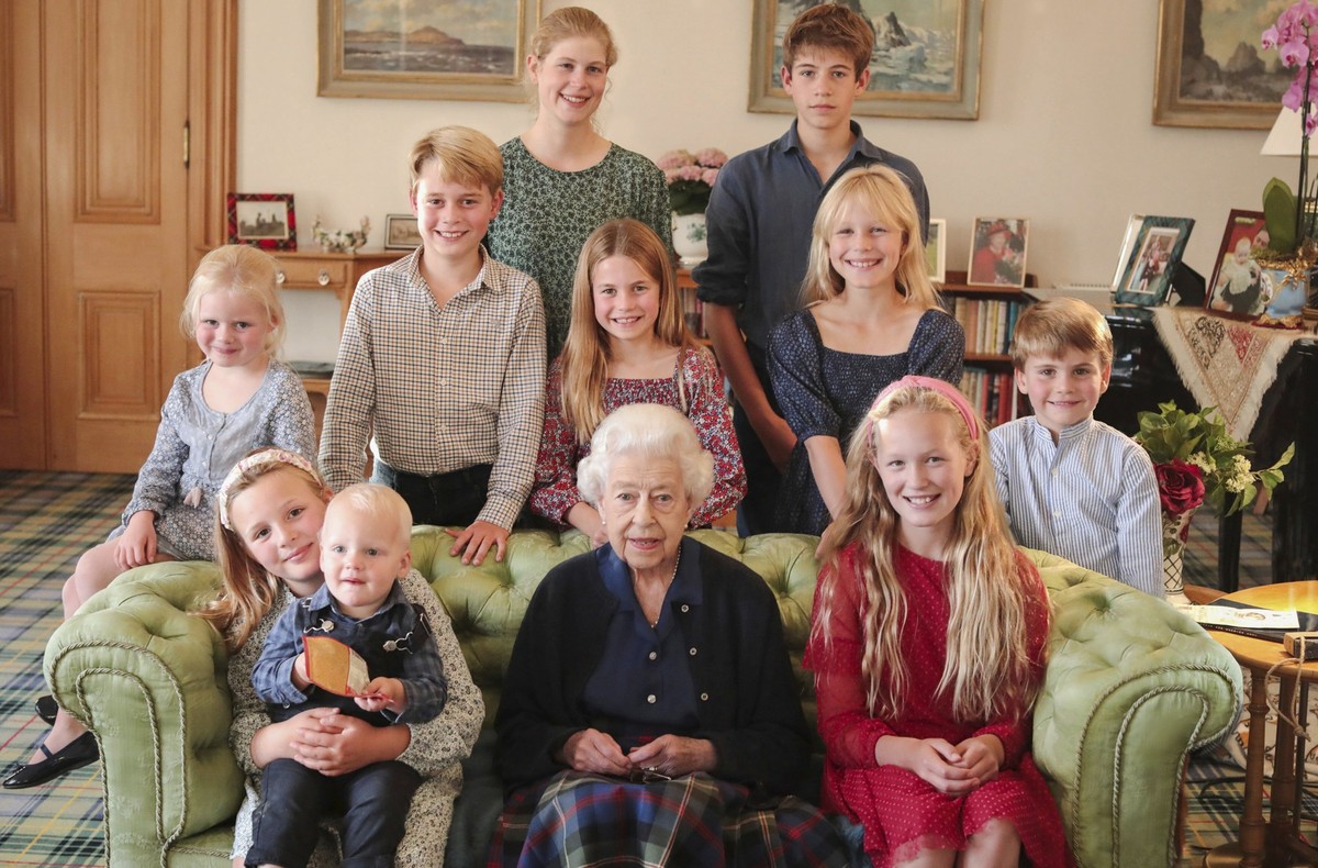 In this undated photo provided by Kensington Palace, Britain&#039;s Queen Elizabeth II poses for a photo in Balmoral, Scotland, with some of her grandchildren and great grandchildren. Back from from l ...
