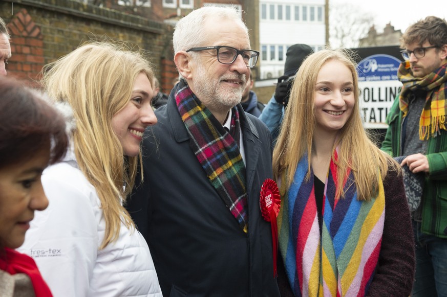 191212 -- LONDON, Dec. 12, 2019 -- British Labour Party Leader Jeremy Corbyn C poses with supporters at a polling station after casting his vote for the general election in London, Britain, Dec. 12, 2 ...