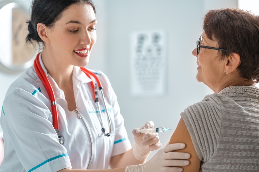 Doctor vaccinating a woman in the clinic.