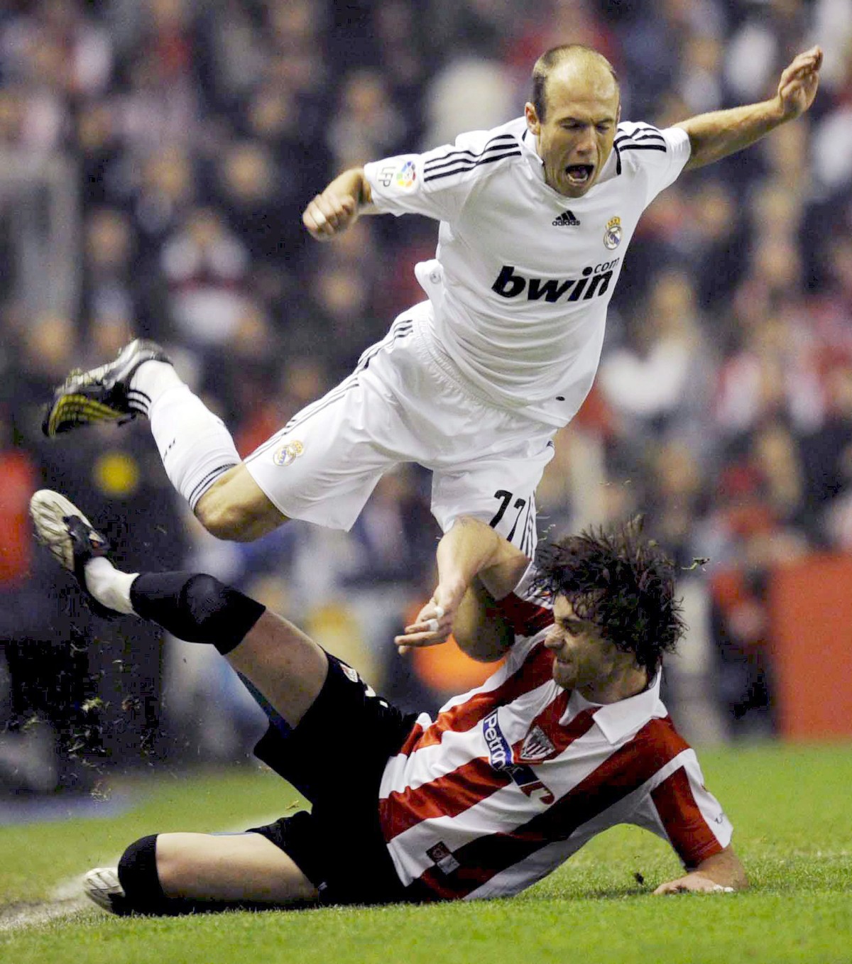 Real Madrid?s Dutch midfielder Arjen Robben (up) falls over Athetic de Bilbao defender Fernando Amorabieta (down) during the Spanish Liga Primera Division match Athletic Bilbao vs Real Madrid at San M ...