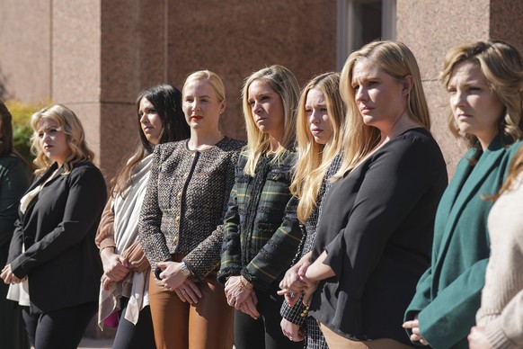 The plaintiffs stand in front of the Texas Supreme Court after oral arguments for Zurawski v. State of Texas were heard, Tuesday, Nov. 28, 2023, in Austin, Texas. (Mikala Compton/Austin American-State ...