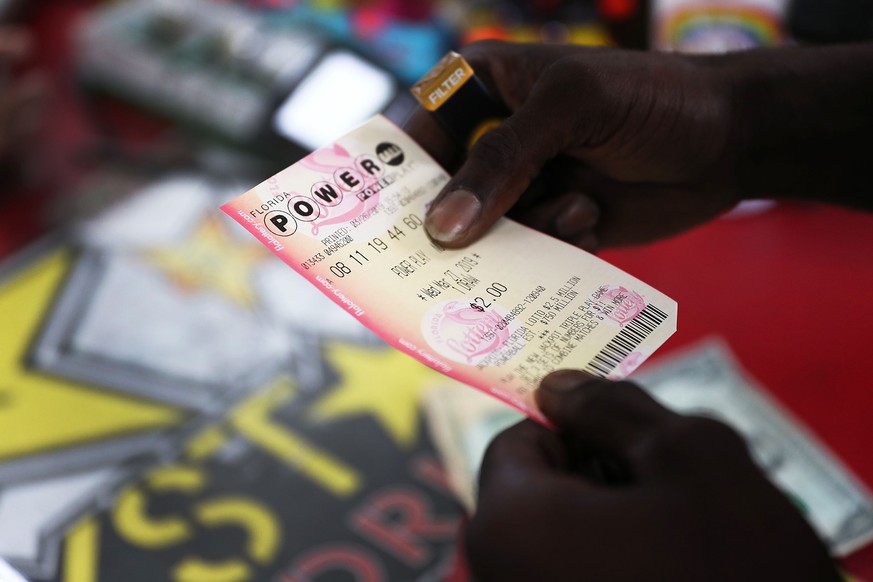 BOYNTON BEACH, FLORIDA - MARCH 26: George Hollins buys a Powerball ticket at the Shell Gateway store on March 26, 2019 in Boynton Beach, Florida. Wednesday's Powerball drawing will be an approximately ...