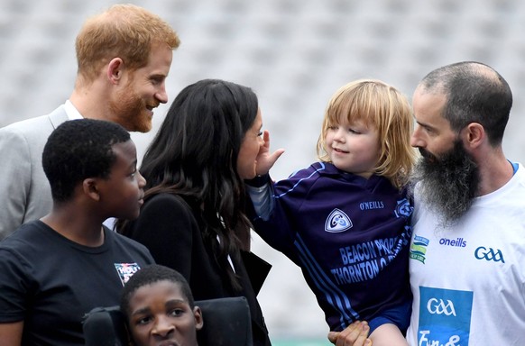 Royal visit to Dublin - Day Two The Duke and Duchess of Sussex interact with a small child during a visit to Croke Park on the second day of their visit to Dublin, Ireland. Photo credit should read: D ...