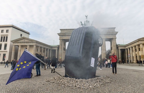 BERLIN, GERMANY - MARCH 22: An installation by Greenpeace activists shows an SUV that is seemingly rammed into the pavement in front of the Brandenburg Gate on March 22, 2023 in Berlin, Germany. Green ...