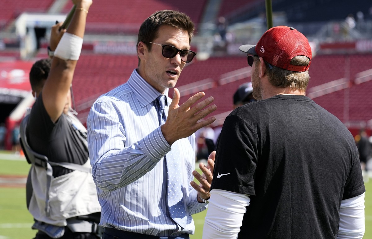Former quarterback Tom Brady, left, talks to Tampa Bay Buccaneers offensive coordinator Liam Coen before an NFL football game between the Buccaneers and the Philadelphia Eagles Sunday, Sept. 29, 2024, ...