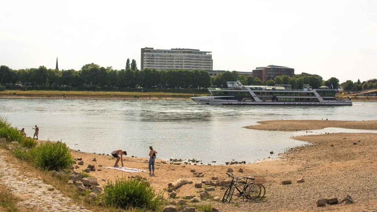 A general view of the bank of the Rhine River in Cologne, Germany, on June 15, 2023, is seen ahead of the dry weather season (Photo by Ying Tang/NurPhoto via Getty Images).