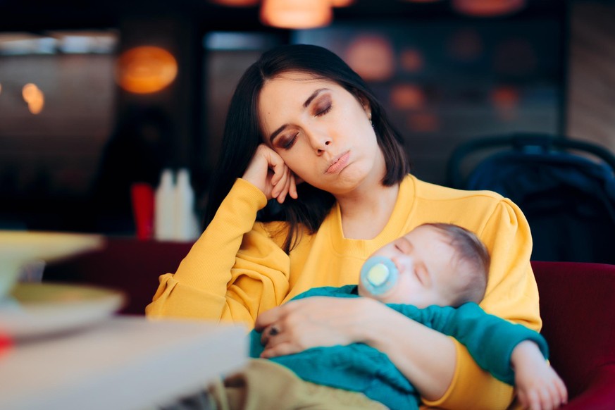 Overwhelmed new mom feeling sleep deprived and fatigued