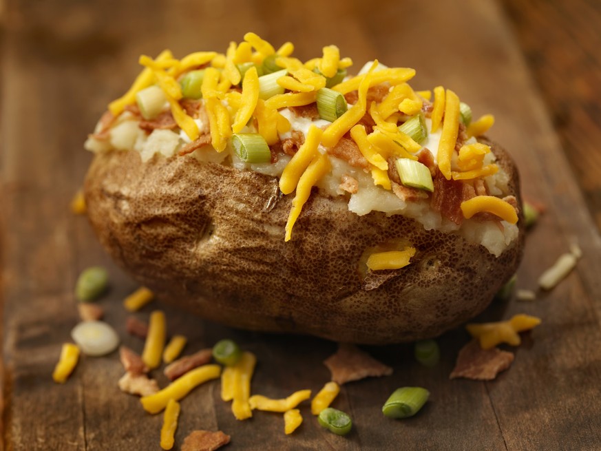 Baked Potato Topped with Bacon, Sour Cream, Green Onions and Cheddar Cheese with Garlic Bread -Photographed on Hasselblad H3D-39mb Camera