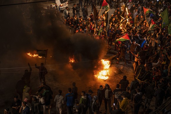 Palestinians celebrate after a shooting attack near a synagogue in Jerusalem, in Gaza City, Friday, Jan. 27, 2023. A Palestinian gunman opened fire outside an east Jerusalem synagogue Friday night, ki ...