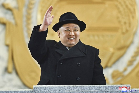 In this photo provided by the North Korean government, North Korean leader Kim Jong Un waves his hand as he looks at a military parade at Kim Il Sung Square in Pyongyang, North Korea, Wednesday, Feb.  ...