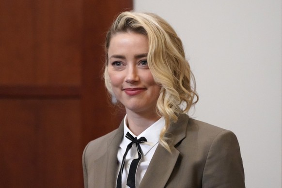 FILE - Amber Heard arrives into the courtroom after a break at the Fairfax County Circuit Courthouse in Fairfax, Va., Monday, May 23, 2022. Actors Johnny Depp and Heard have settled their defamation l ...