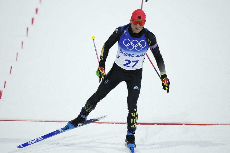 Erik Lesser of Germany crosses the finish line during the men's 20-kilometer individual race at the 2022 Winter Olympics, Tuesday, Feb. 8, 2022, in Zhangjiakou, China. (AP Photo/Frank Augstein)