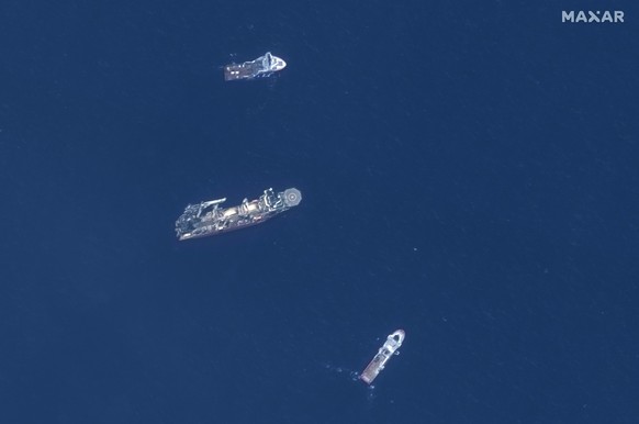 In this satellite image provided by Maxar Technologies, from top to bottom, the vessels Horizon Arctic, Deep Energy and Skandi Vinland search for the missing submersible Titan, Thursday, June 22, 2023 ...