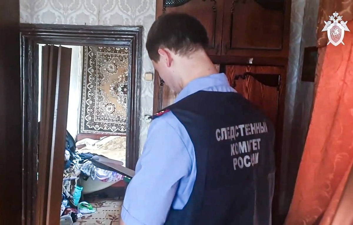 RUSSIA, CHELYABINSK REGION - JULY 31, 2023: An investigator of the Russian Investigative Committee operates in a house where, according to preliminary data, a woman who was abducted in 2009, was held  ...