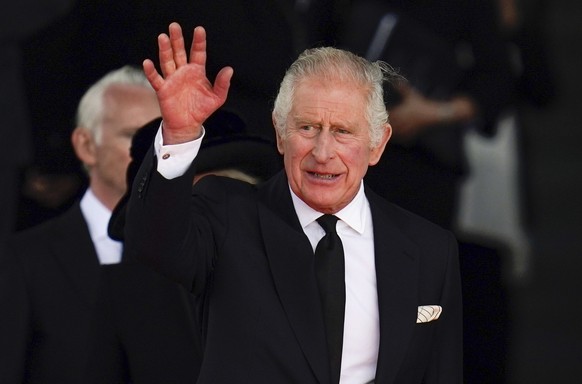 King Charles III waves to the crowd as he leaves the Senedd, after a visit to receive a Motion of Condolence following the death of Queen Elizabeth II, in Cardiff, Wales, Friday, Sept. 16, 2022. King  ...