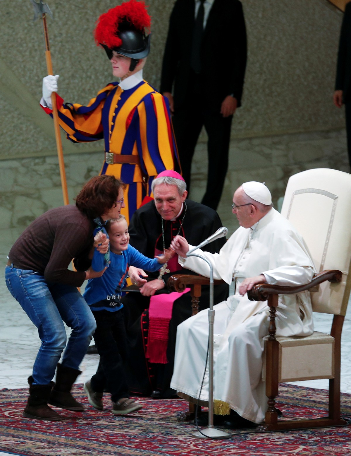 A boy held by his mother reacts during the general audience led by Pope Francis at Paul VI hall at the Vatican, November 28, 2018. REUTERS/Max Rossi