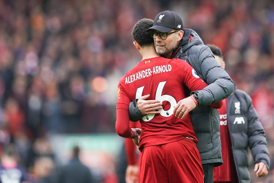 Football - 2019 / 2020 Premier League - Liverpool vs. AFC Bournemouth Liverpool manager J�rgen Klopp hugs Liverpool s Trent Alexander-Arnold at the end of the match, at Anfield. COLORSPORT/TERRY DONNE ...