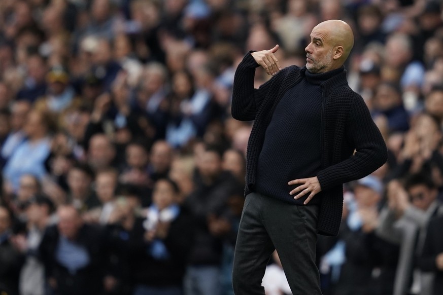 Manchester City&#039;s head coach Pep Guardiola gestures during the English Premier League soccer match between Manchester City and Wolverhampton Wanderers at the Etihad Stadium in Manchester, England ...