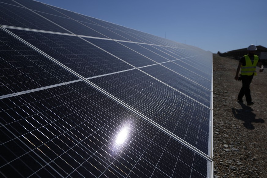 A maintenance engineer walks at a new solar park outside the northern Greek city of Kozani on Friday, June 3, 2022. The newly-completed solar park, one of Europe&#039;s largest, is just a half-hour dr ...