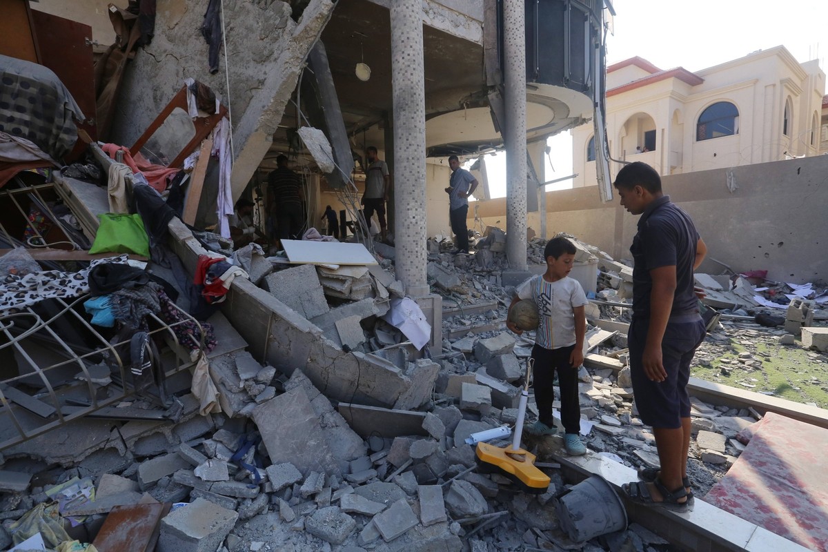 Palestinians inspect the damaged following overnight Israeli bombardment of a house at the Nuseirat refugee camp Palestinians inspect the damaged following overnight Israeli bombardment of a house at  ...
