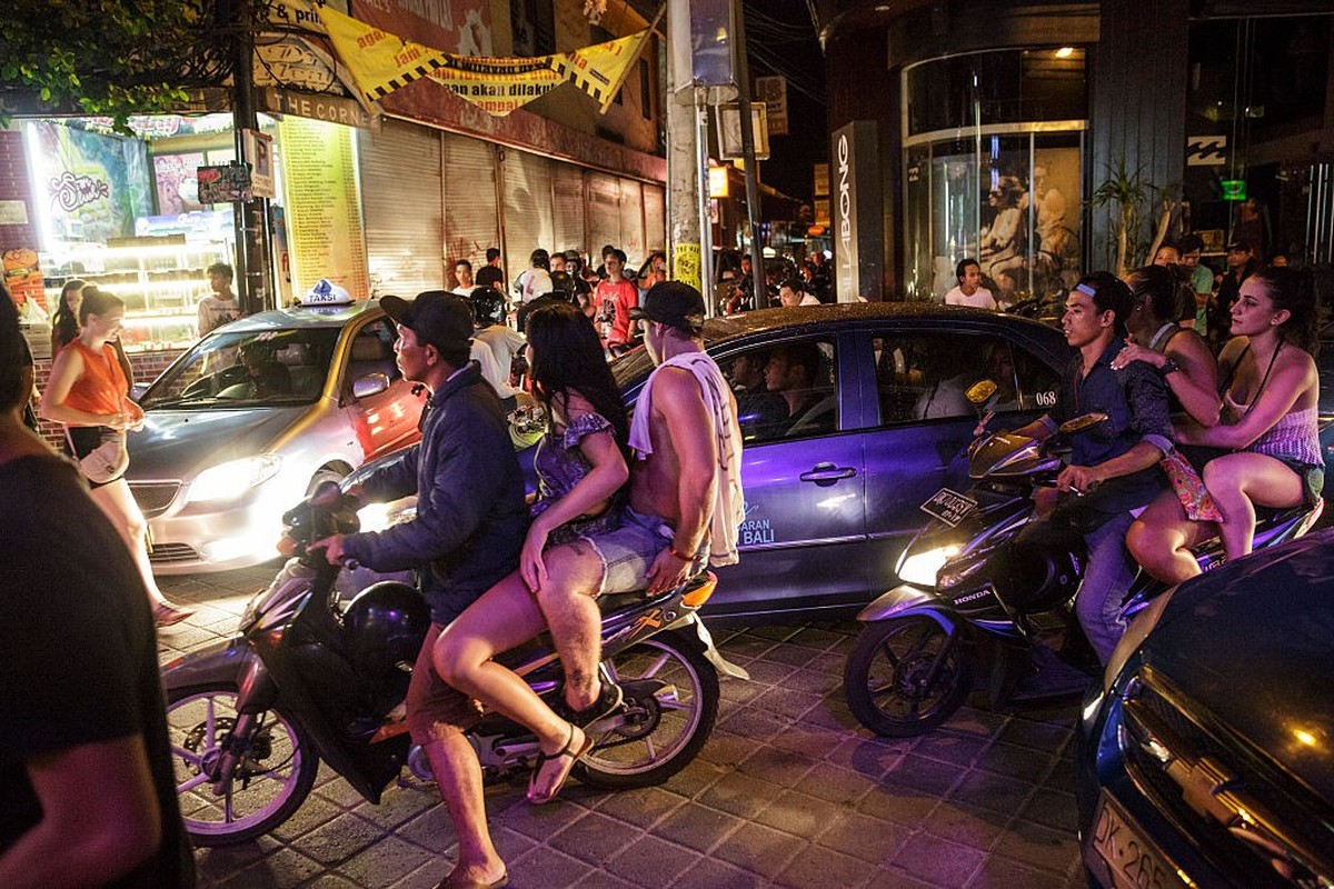 KUTA, BALI, INDONESIA - NOVEMBER 26: Teenagers ride motorbike taxis on Legian Street during Australian &#039;schoolies&#039; celebrations on November 26, 2014 in Kuta, Bali, Indonesia. This year aroun ...