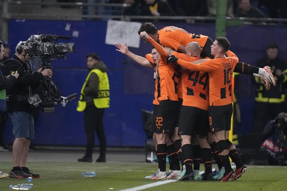 Shakhtar players celebrate the opening goal of their team during the Champions League Group H soccer match between Shakhtar Donetsk and Barcelona, at the Volksparkstadion in Hamburg, Germany, Tuesday, ...