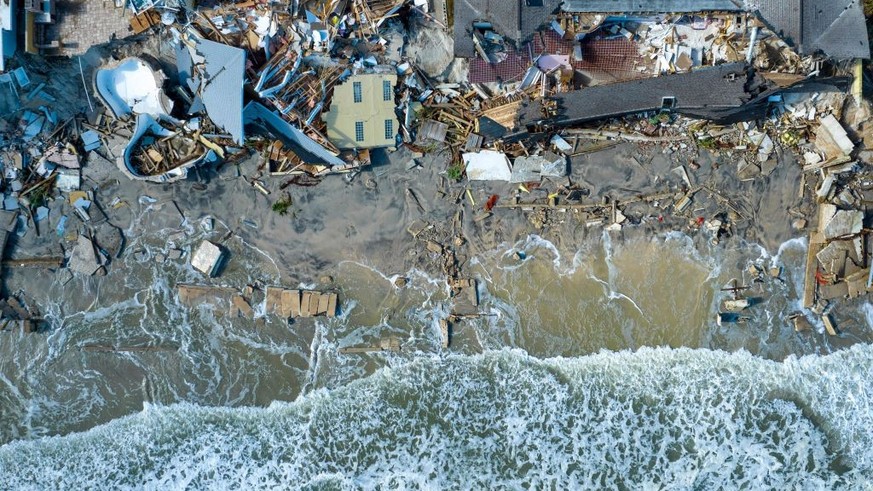 An aerial view of destroyed beachfront homes in the aftermath of Hurricane Nicole at Daytona Beach, Florida, on November 11, 2022. - The rare late storm sparked mandatory evacuation orders just weeks  ...