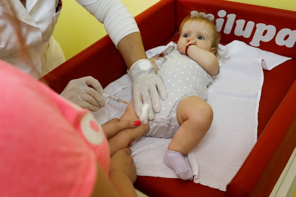A child receives a vaccine in a hospital in Belgrade, Serbia, September 3, 2018. REUTERS/Marko Djurica